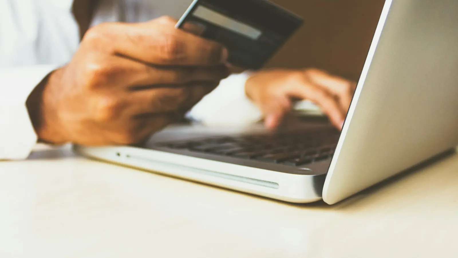 Paying for a travel document online with a card and laptop