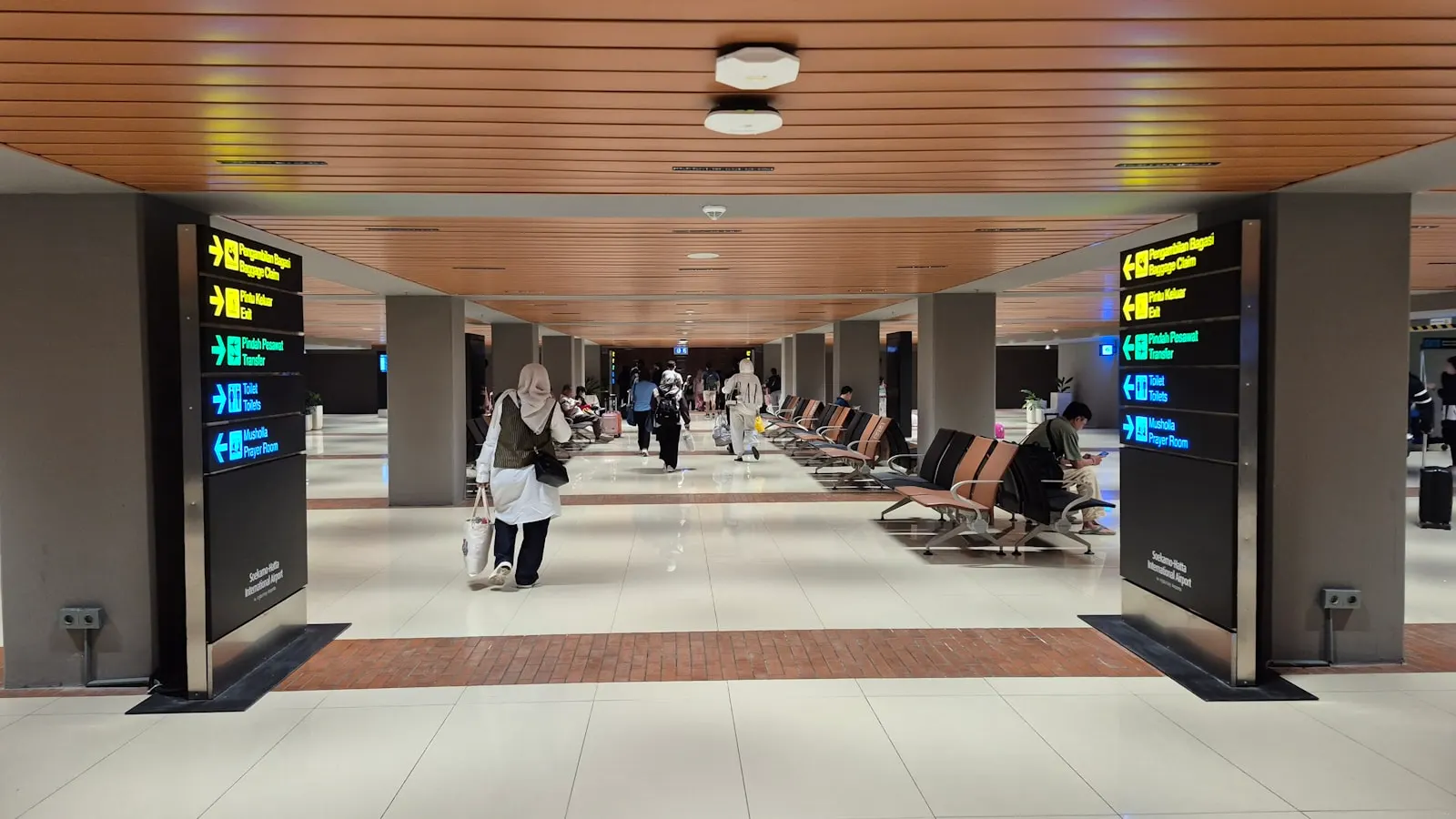 Travellers in an airport arrivals hall